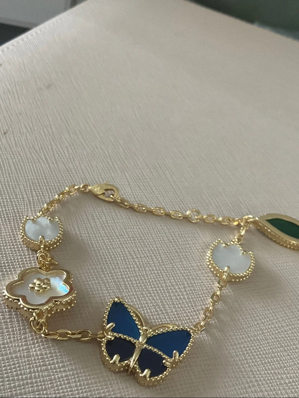 Anthropologie Gold Bracelet with Blue Butterfly and Green Charm